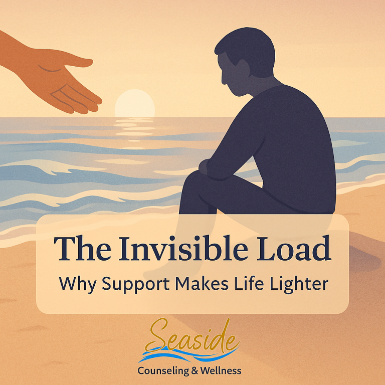 Illustration of a person sitting on a beach at sunset with an outstretched hand reaching toward them, symbolizing support and relief, with the text “The Invisible Load — Why Support Makes Life Lighter” and the Seaside Counseling & Wellness logo.