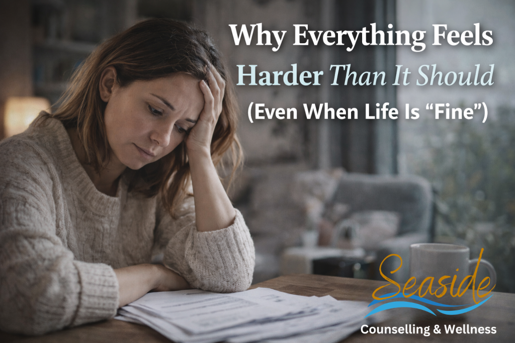 Person sitting quietly by a window, reflecting emotional fatigue and feeling overwhelmed even when life appears calm and stable