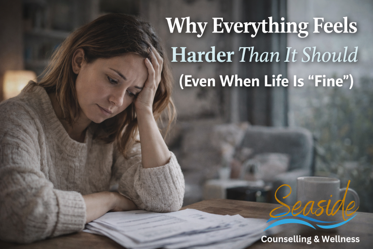 Person sitting quietly by a window, reflecting emotional fatigue and feeling overwhelmed even when life appears calm and stable