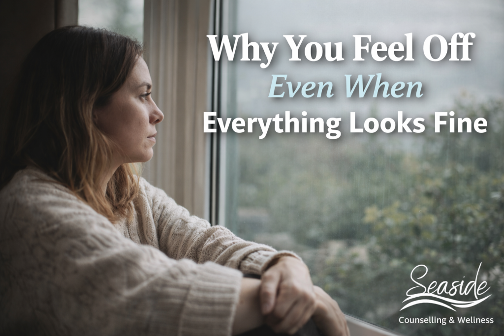 Person sitting quietly by a window, reflecting a sense of feeling off or emotionally disconnected despite a calm environment